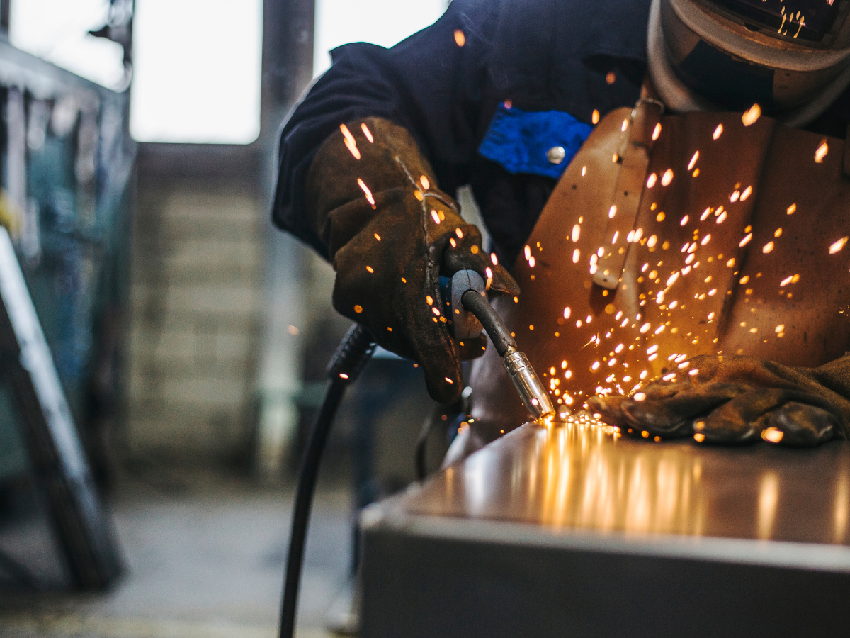 Alt text: Welder welding after installing a welding fume extraction system