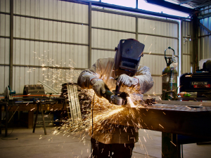 Welder working at a workshop setup for best practices for fume control